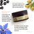 Eye cream jar with olive, black currant, and borage seed oil text on a white background