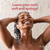 Woman with wet hair smiling under a shower with text 'Leave your curls soft and springy!'
