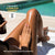 Person applying tanning lotion to their legs by a pool with text about sunless tanning products.