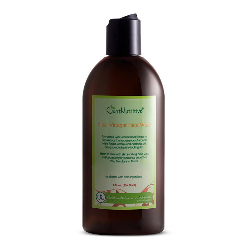 Brown bottle of Just Born Clear Vinegar Face Wash on a white background