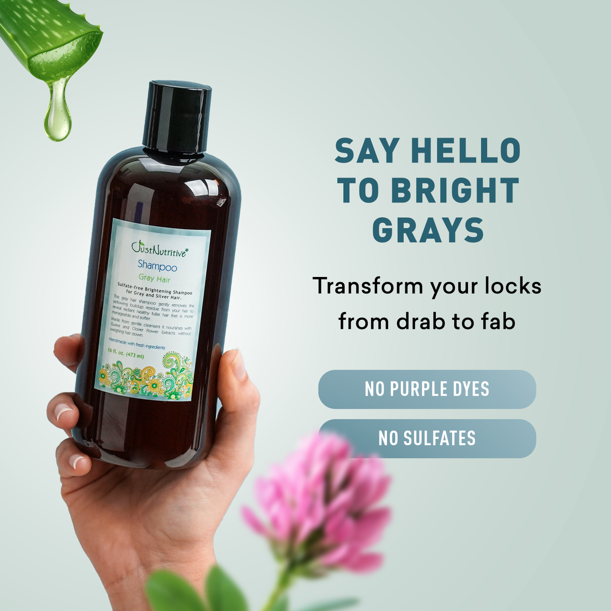 Bottle of shampoo held by a hand with text promoting hair care product, featuring a green leaf and pink flower.