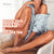 Woman with a flawless tan sitting on a chair, promoting a product for a golden tan.